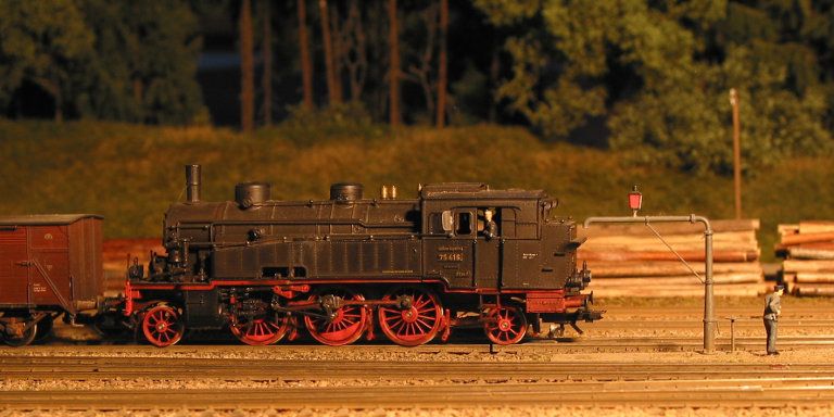 Foto der Modellbahnanlage: Lokomotive schiebt Güterwagen.